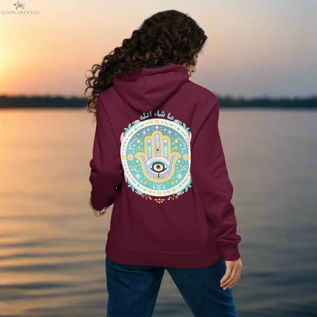 The back of a hoodie from Soonaboosh, featuring a colorful Hamsa hand design with the Arabic word "Mashallah" above it.