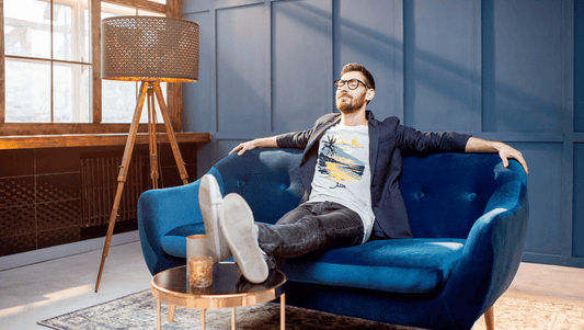Man relaxing in Arabic tshirt that says "tannish" or "let it go"