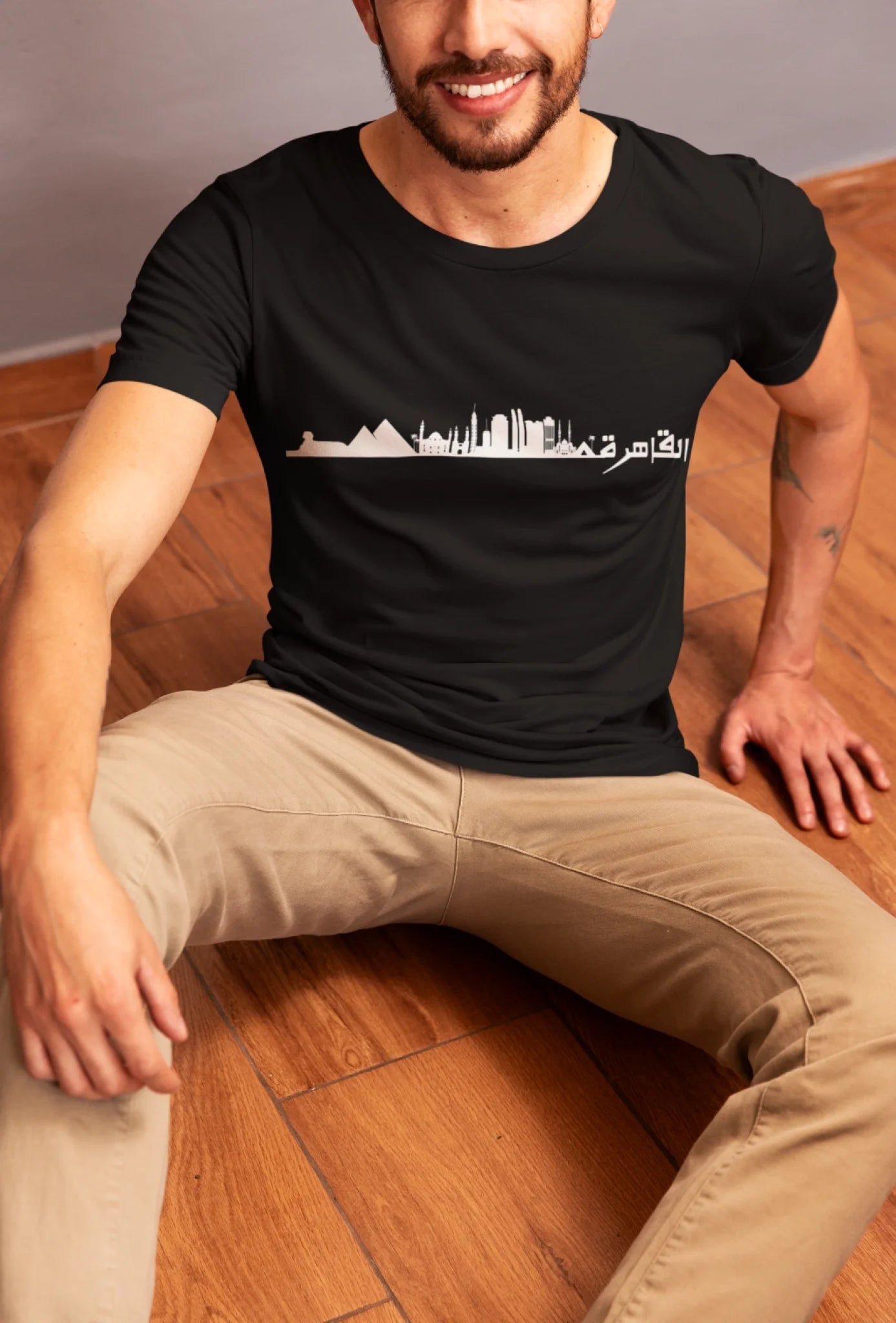 bella-canvas-t-shirt-mockup-featuring-a-smiling-cropped-face-man-sitting-on-a-wooden-floor-m50067